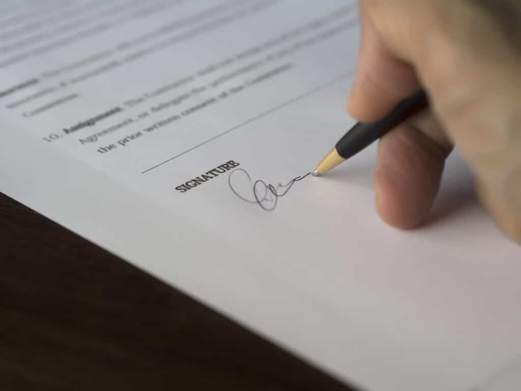 Hand Signing Immigration Bond Paperwork
